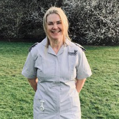 Tracey Porter smiling in her nursing uniform