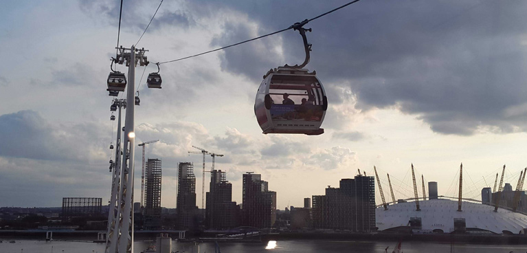Cable car crossing the Thames with views to the city and the O2