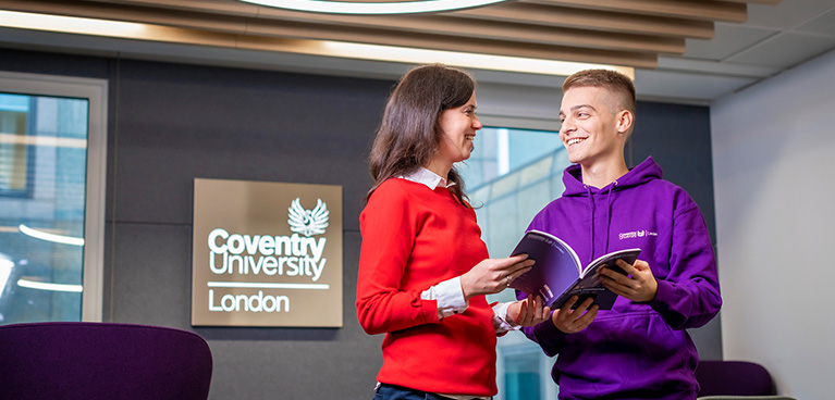 A student talking to a student ambassador at Coventry University London