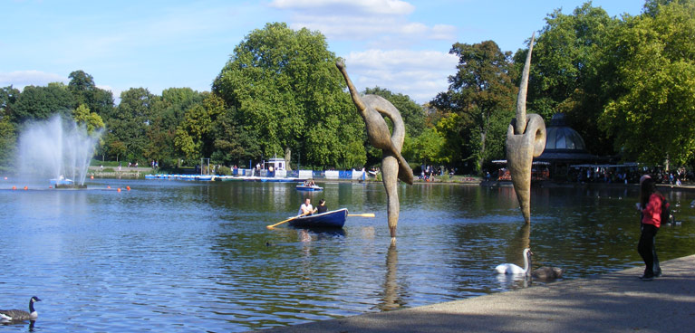 A boat and sculptures in the lake at at Victoria Park