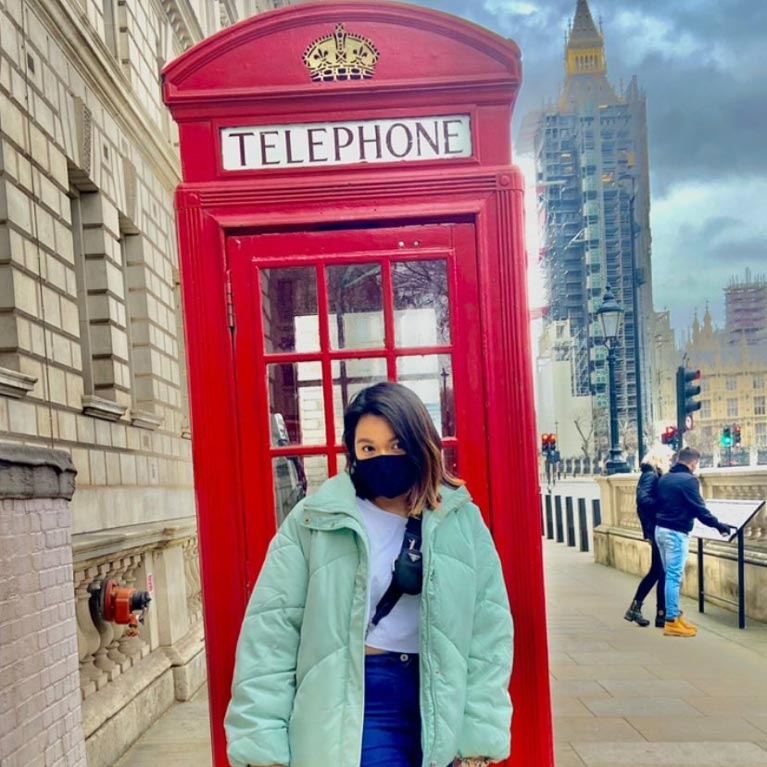girl in front of red telephone box