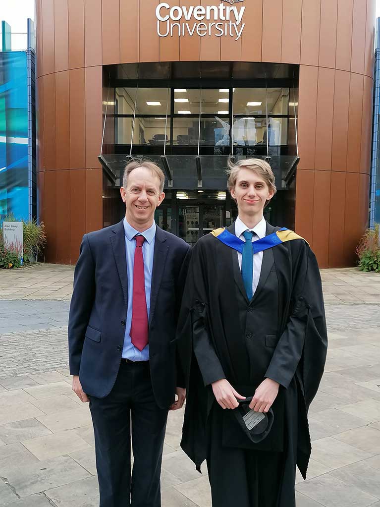 Phil Adcock stood with his son at his graduation