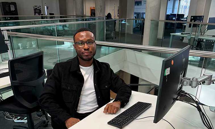 Destiny Omorogieva sat on a desk in Coventry University