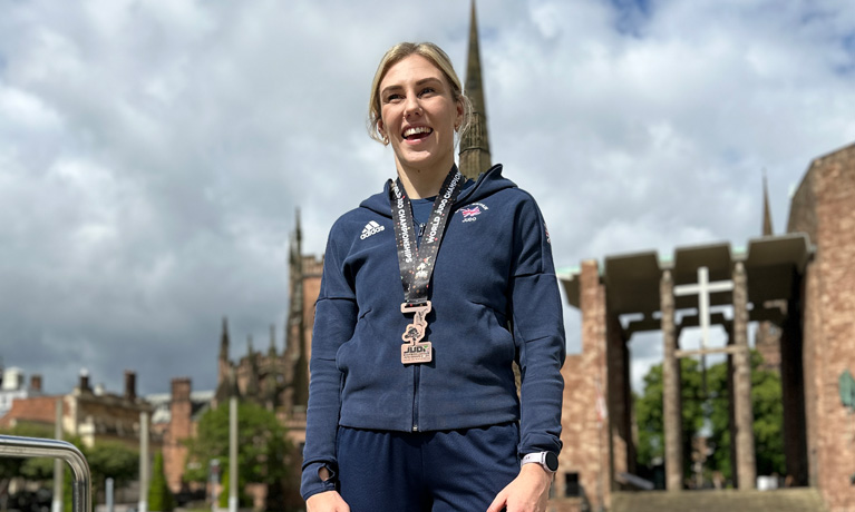 Emma Reid standing outside the Cathedral in Coventry