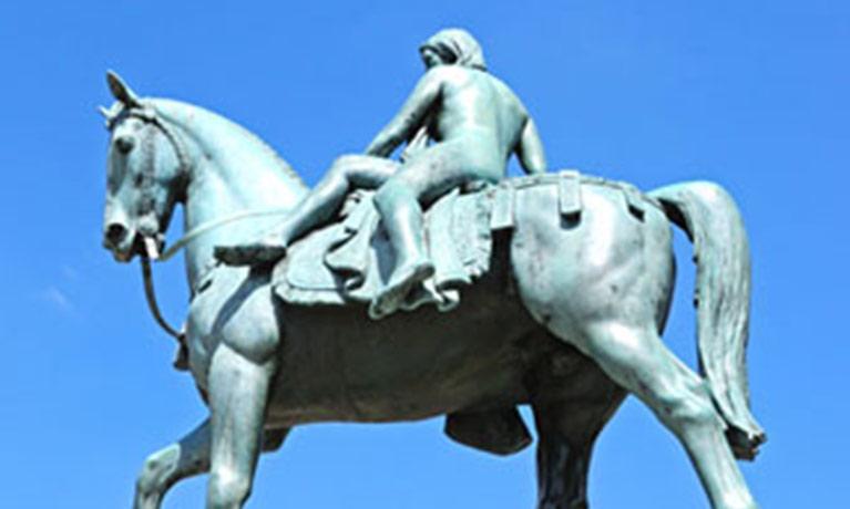 Godiva statue against a blue sky