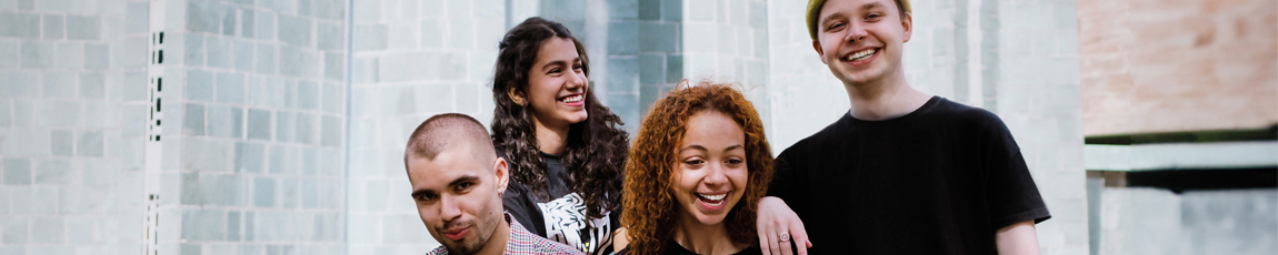 A group of international students smiling outside.