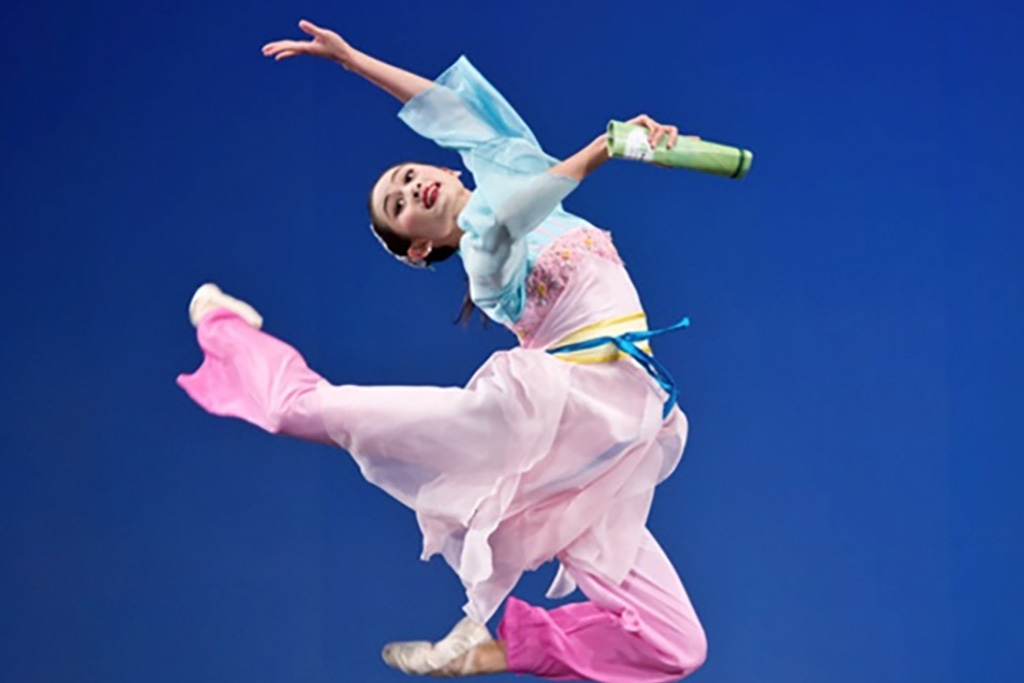 A Chinese dancer leaps in the air.