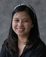 Portrait of Louisa Sugihyanto against a grey background