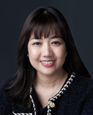 Portrait of Meili Nongnuch against a dark background