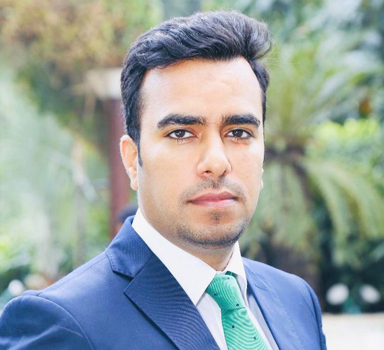 Portrait of Tarang Chowdhary with greenery in the background Portrait of Tarang Chowdhary with greenery in the background