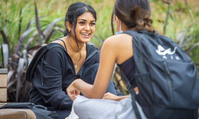 Two students sitting on campus.