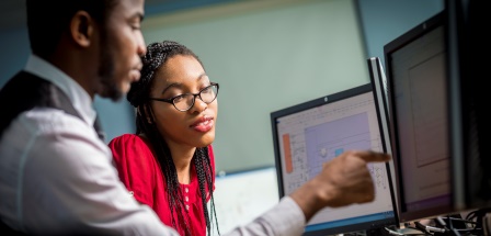 Two students looking at a screen