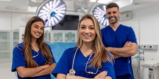 Operating practitioners crossing their arms and smiling