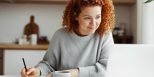 A student studying with a laptop and earphones