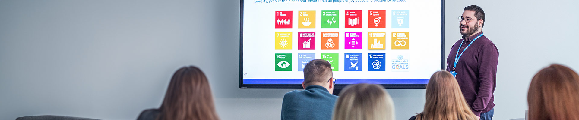 Man presenting infront of a digital whiteboard