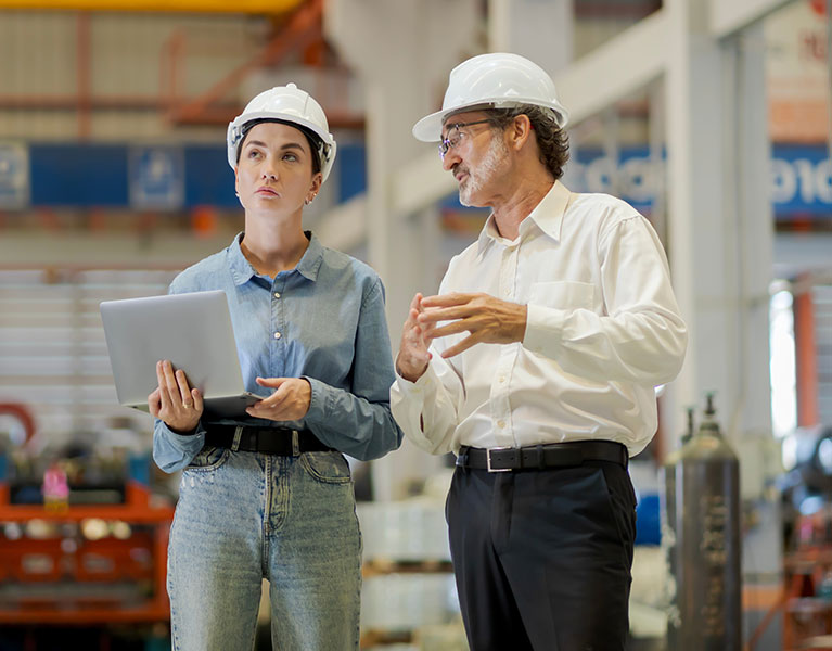 two engineers talking in a workshop