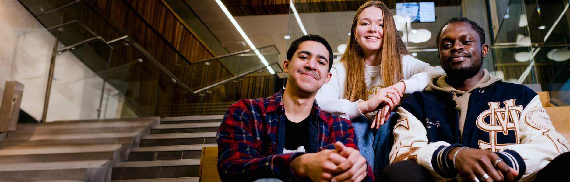 Group of students smiling on a staircase