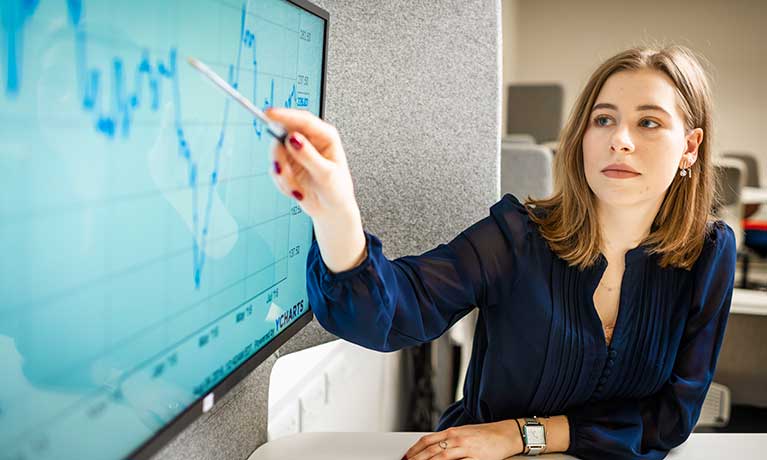 Woman pointing at screen in the Business Simulation Suite