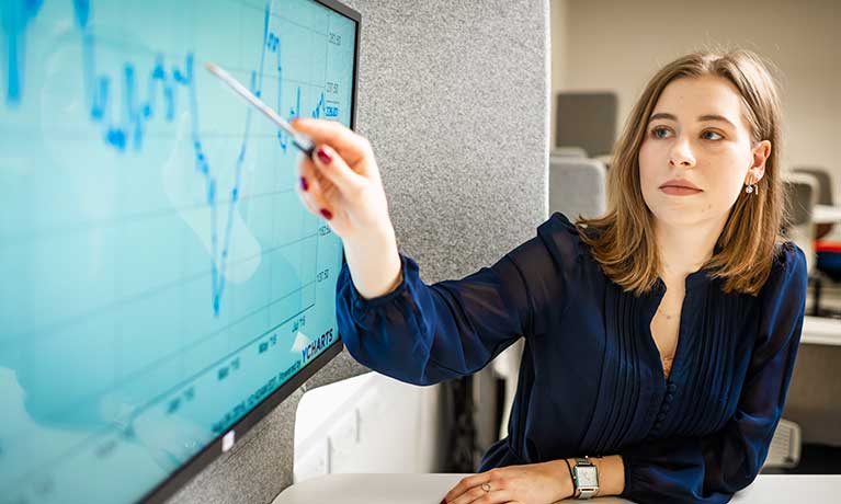 Student looking at graph on monitor