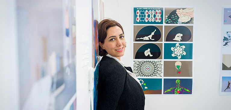 Student standing next to their work