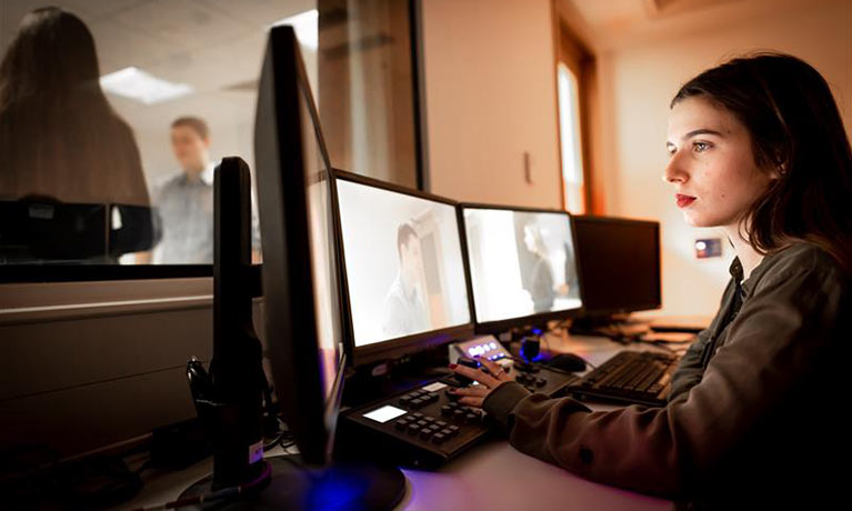Student looking at screens monitoring