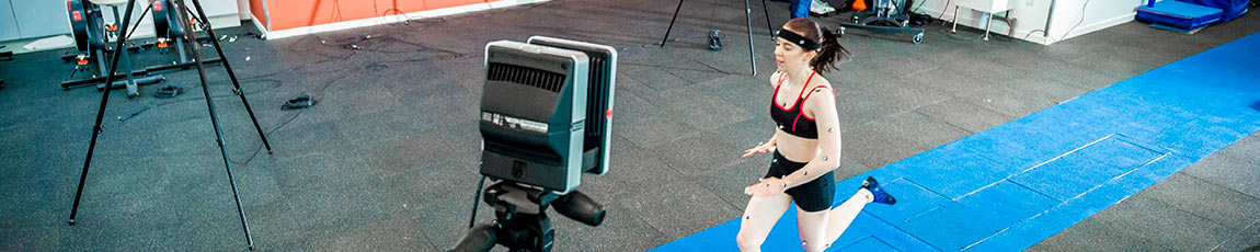Woman running down a blue strip with tracking technology