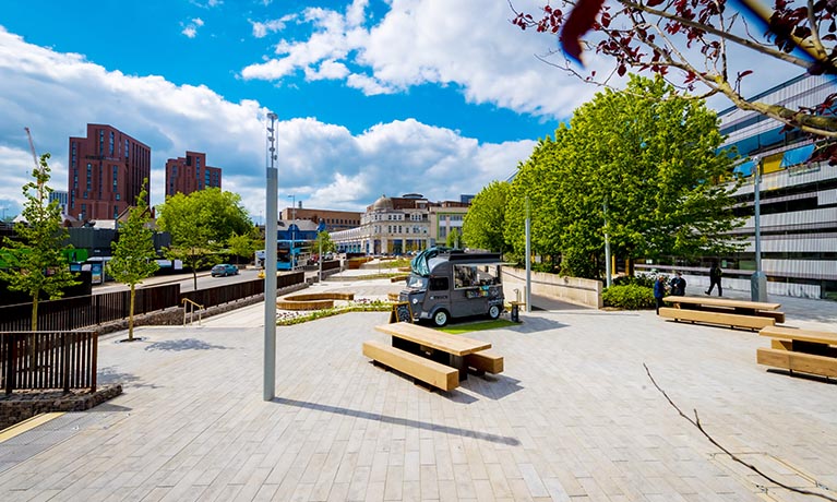 Starley Gardens with trees, benches and a coffee van