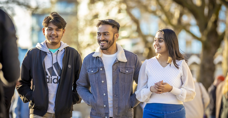 Student smiling walking together on a bright day