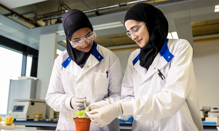 Two female student working in a lab