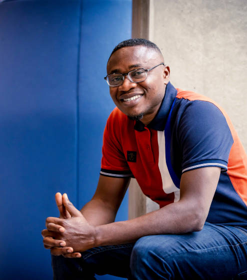 A man sitting down and smiling