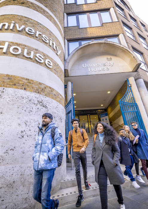 Outside view of University House with people walking out