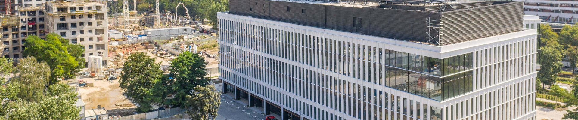 picture of a completed big building surrounded with construction sites