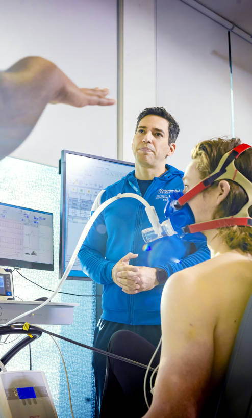 Lecturer stood in front of a male with an oxygen mask
