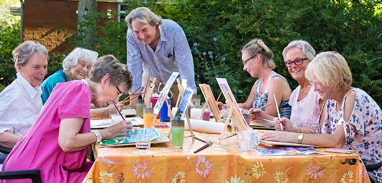 Older people painting outdoors