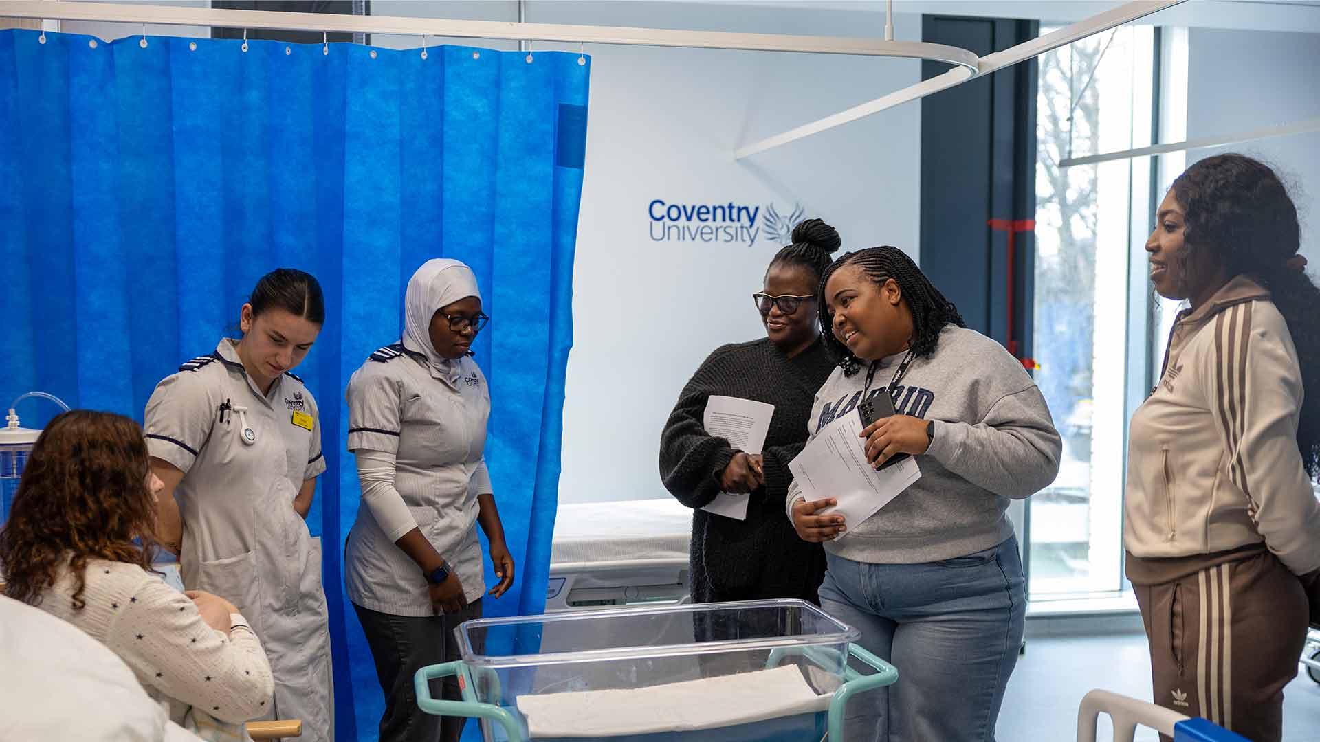 Students in a ward helping a patient