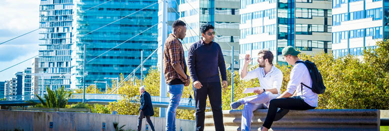 Male students sat outside campus