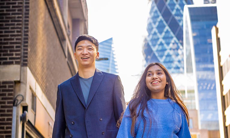 Male and female student walking in London