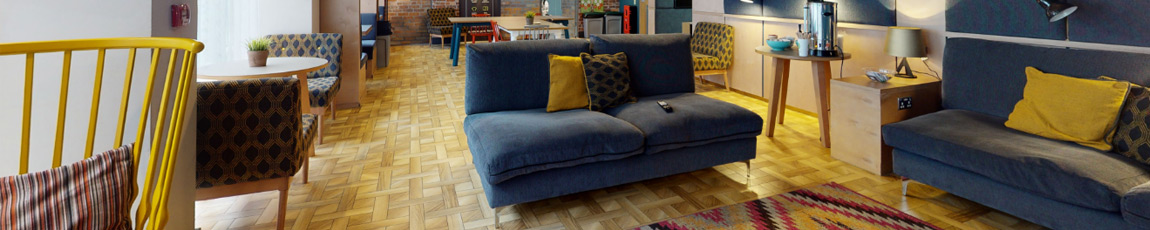 The comfortable communal interior of Magenta House, with sofas and chairs.