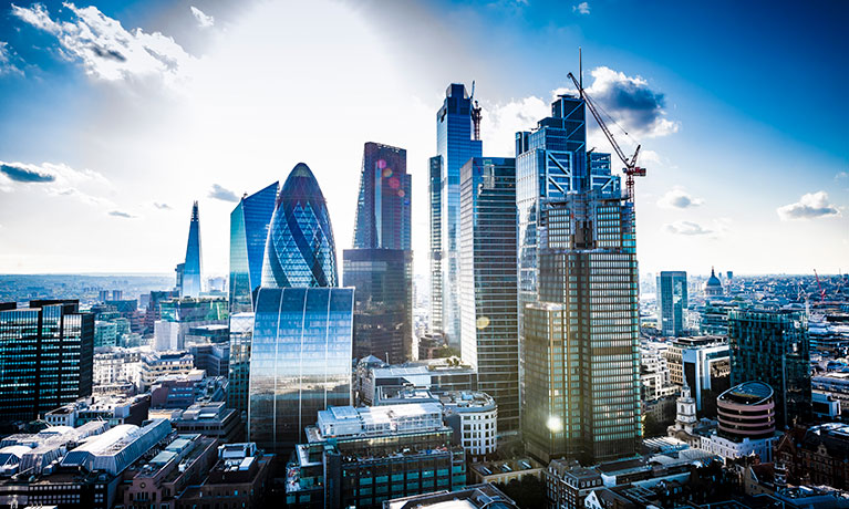 Tall office buildings on the London skyline on a sunny day.