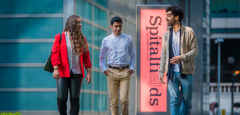 Students walking together in front of the Spitalfields building