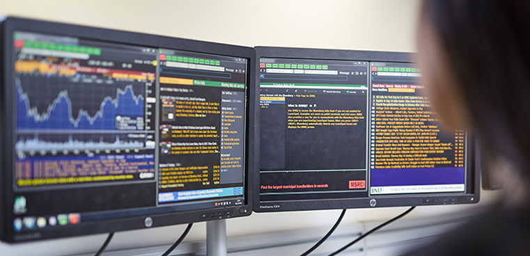 student looking at statistics on multiple screens