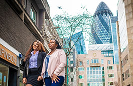 Two students walking through London street