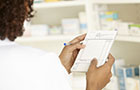 Close up of a pad and hands where a nurse is prescribing medicine