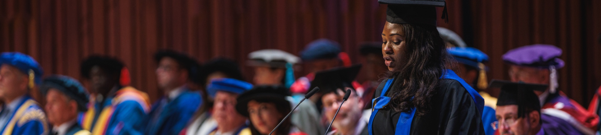 University graduate giving a speech at a graduation ceremony