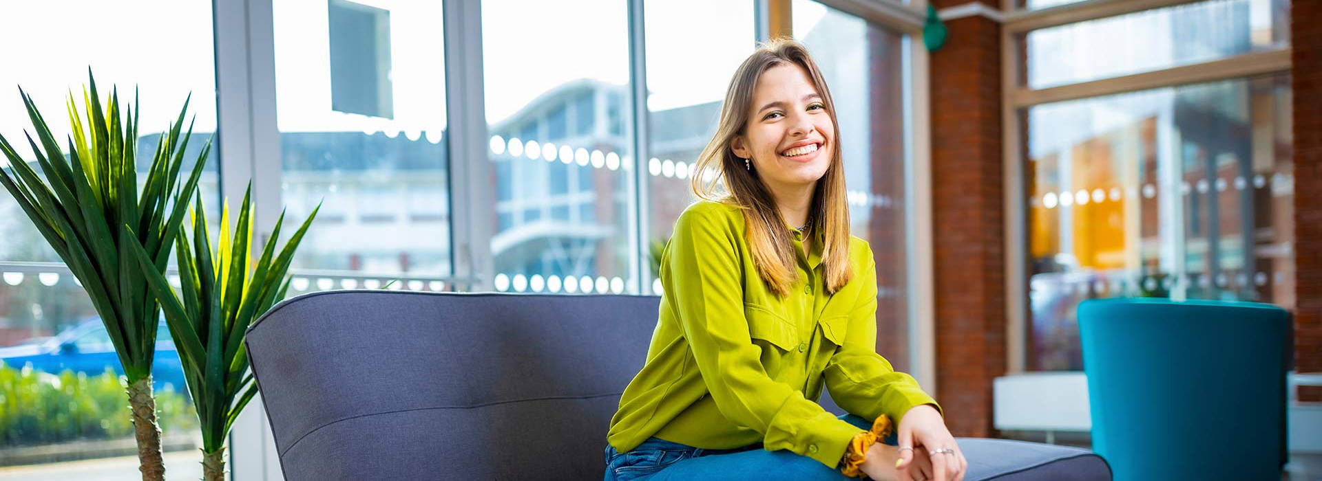 Female student sat down smiling