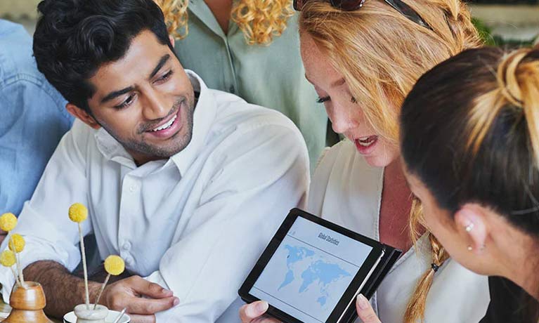 Female explaining content on an iPad to her colleagues