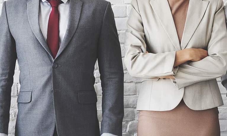 Male and female employee's facing the camera in smart clothing