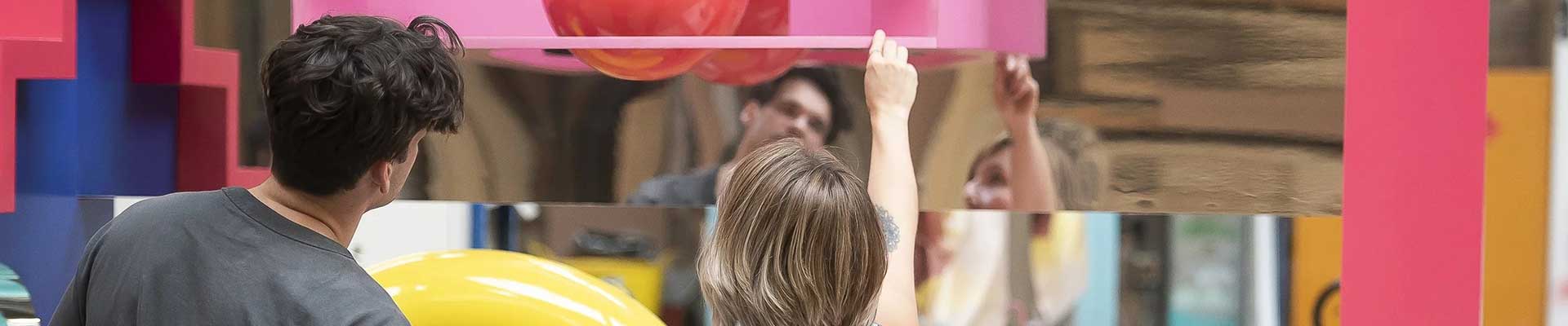 Creative people working on a large colourful display