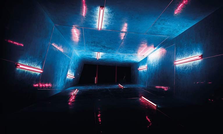 dark lift shaft with strip lighting on the shaft walls