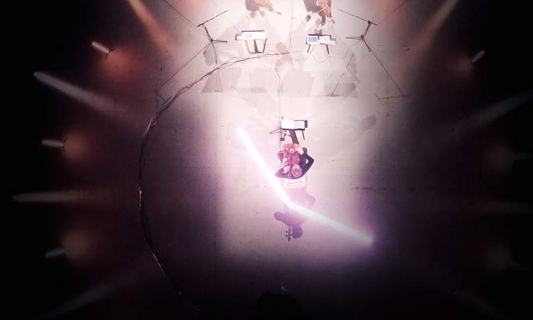 aerial view of an orchestra  in a spotlight on it